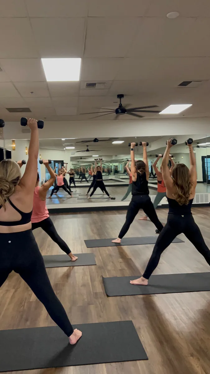 A member in a hot yoga class at Sacred Studios